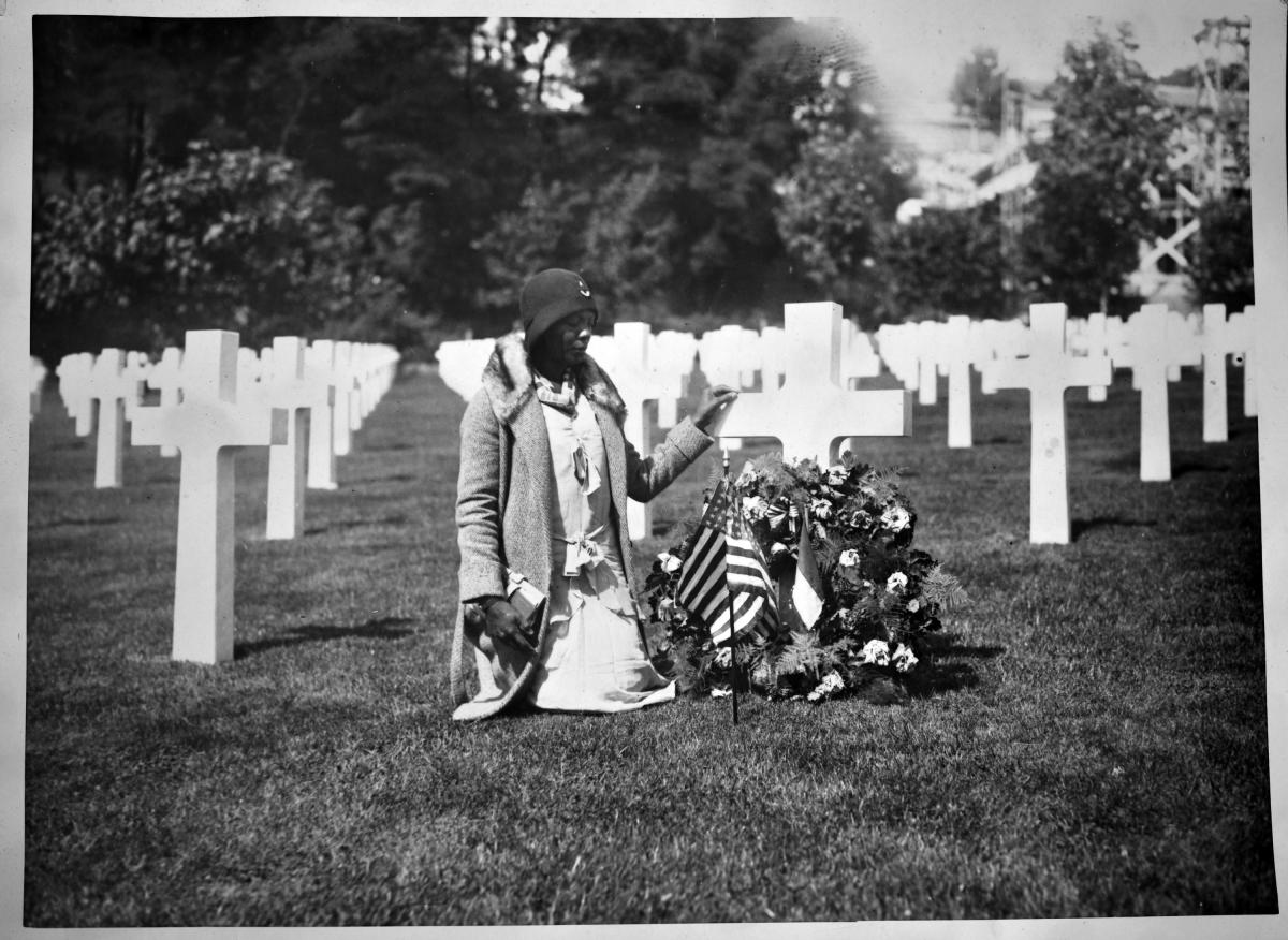 A woman visits a loved one's grave in France